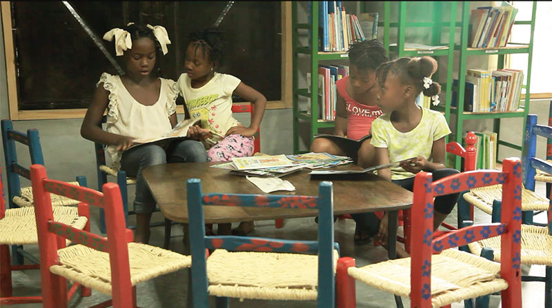 Haitian girls reading in library
